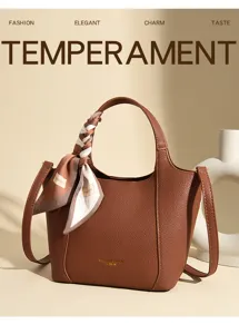 Stylish brown leather bucket bag with chic twilly scarf decoration, perfect for daily wear.