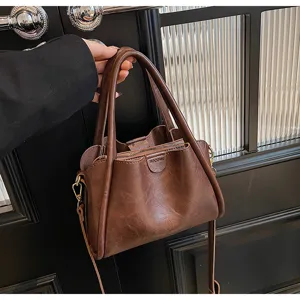 Detail view of the dark brown soft PU leather handbag, showing texture and hardware.