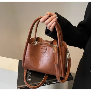 Stylish brown PU leather handbag for women, large capacity shoulder and crossbody bag detail.