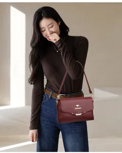 Stylish women red leather shoulder bag, casual crossbody bag with metal lock and large capacity.