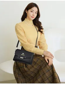 Elegant black leather women crossbody bag, fashion casual shoulder handbag with metal accent.