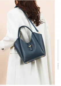 Genuine leather hobo shoulder bag for women, stylish bucket handbag with metal lock detail.