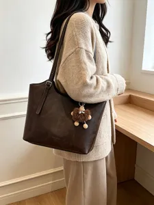 Chic vintage brown tote bag for women, large capacity leather shoulder bag with plush charm.
