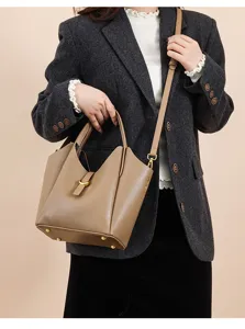 Genuine leather bucket bag detail view, soft litchi pattern texture with metal hardware.