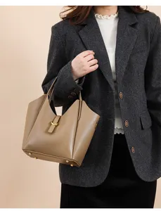Genuine leather bucket bag detail showing soft litchi pattern texture and metal loop.