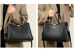 Detail view of stylish black womens handbag with soft leather and elegant gold hardware.