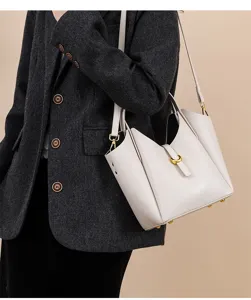 Detailed view of women genuine leather bucket bag, showing premium litchi pattern and gold hardware.
