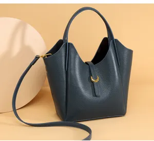 Detailed view of genuine leather bucket bag, soft litchi pattern, elegant shoulder strap design.
