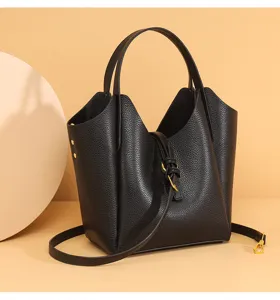 Detail view of black genuine leather bucket bag, showing premium litchi pattern texture.