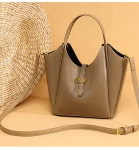 Detail shot of the genuine leather bucket handbag showing premium litchi texture and metal hardware.