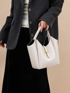 Genuine leather bucket bag for women, stylish litchi pattern handbag with metal closure.