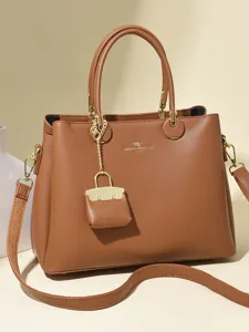 Classic brown leather handbag with top handles, crossbody strap, and chic hardware details.