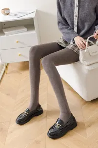 Detail view of grey vertical stripe fleece-lined pantyhose, warm winter thermal leggings for women.
