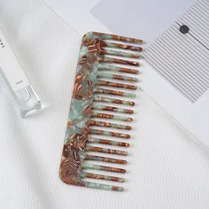 Detail shot of the acetate wide-tooth hair comb with elegant marble pattern for daily use.