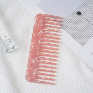 Pink acetate hair comb with marble pattern, wide tooth anti static daily styling hair care tool.