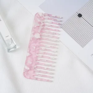 Pink marble acetate hair comb, anti-static wide tooth hair styling tool detail view.