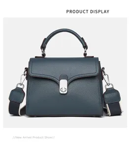 Classic blue leather top handle crossbody bag for women with chic metal lock and strap.