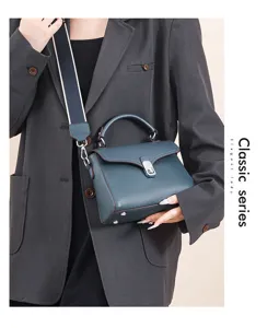 Classic leather top-handle crossbody bag for women, stylish small square tote with wide strap.