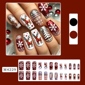 Christmas press on nails detail view showing handmade deer and snowflake patterns with glitter.