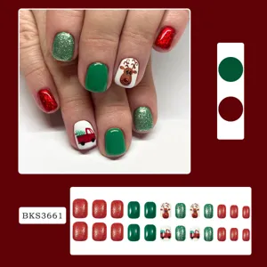 Christmas press-on nail tips detail view featuring cute reindeer and glitter red green.