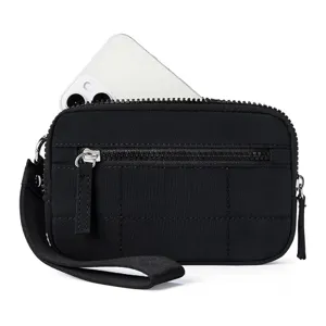 Black quilted mini wristlet bag detail, featuring durable zippers and a handy wrist strap.