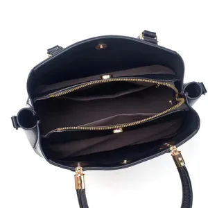 Interior detail of black leather tote bag with multiple zipper pockets and gold hardware.