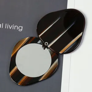 Portable small swivel cover round makeup mirror, acetate sheet material with elegant stripe design.