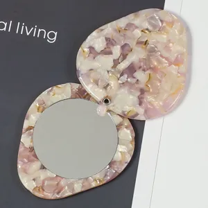 Portable mini acetate makeup mirror with rotating cover, cute pink tortoiseshell design.