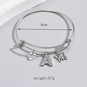 Close-up detail of adjustable silver wire bracelet with sparkling rhinestone letter A charm.