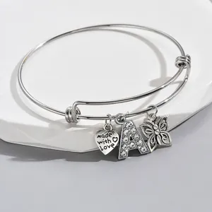 Silver adjustable bangle bracelet with rhinestone letter A, butterfly and love charms.