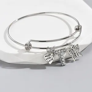Adjustable silver tone wire bangle bracelet featuring rhinestone letter T heart butterfly charms.