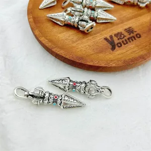 Detailed close-up shot of antique silver alloy DIY Buddhist Dorje pestle pendants.