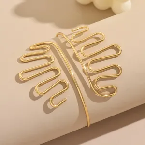 Vista dettagliata del bracciale da braccio geometrico in filo dorato con design punk unico.