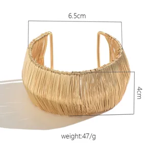 Wide gold wire cuff bracelet, metallic open bangle with hollow design, elegant statement jewelry.