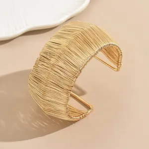 Gold multi-strand wire wrapped wide cuff bracelet, statement open metal bangle detail view.