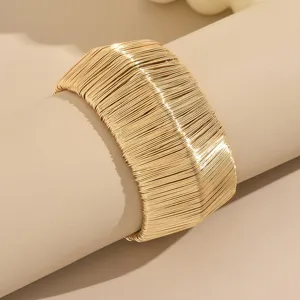 Exaggerated metal wire bangle bracelet, hollow brushed texture wide open cuff detail.