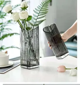 Grey ribbed glass vase with heart-shaped opening, elegant modern home decor detail view.