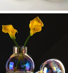 Close up view of Nordic iridescent glass vase featuring vibrant yellow flowers for home decor.