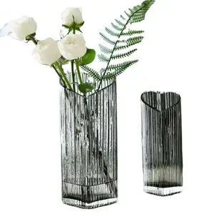 Modern heart-shaped glass vase for home decor, clear striped flower arrangement container.