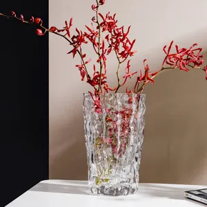 Transparent glass vase with ice glacier ribbed design for modern luxury home decor.