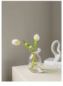 Transparent iridescent glass mini vase with white tulips, elegant table decor for fresh flowers.