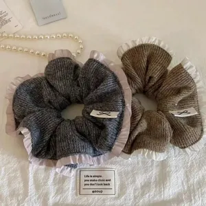 Cozy knit hair scrunchies with elegant ruffled edges, soft winter hair accessories for women.