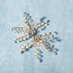 Detailed shot of handmade pearl and crystal shoe clips, elegant bridal shoe flower accessories.