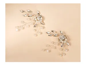 Detailed closeup of exquisite crystal rhinestone and pearl shoe clips for bridal wedding shoes.