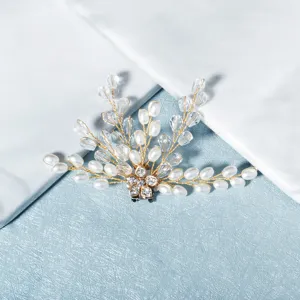 Detailed close-up of handmade pearl and crystal bridal shoe clip accessory with floral design.