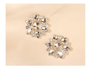 Close-up of sparkling rhinestone flower shoe clips, crystal metal bridal accessories detail.