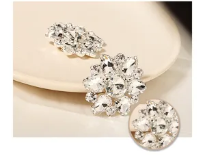 Sparkling rhinestone flower shoe clips, detailed close-up shot of bridal wedding accessories.