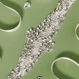 Detailed view of the sparkling rhinestone bridal belt with delicate white ribbon and clear crystal gems.