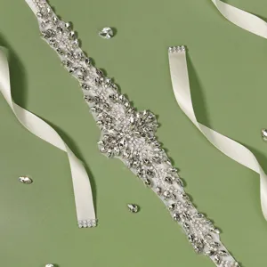 Detailed shot of luxurious bridal rhinestone sash belt with sparkling crystals and white ribbons.