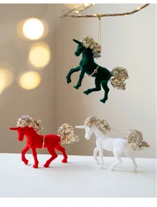 Close-up detail shot of velvet Christmas unicorn ornaments with sparkly sequin manes.